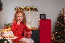Little girl with a gift and cake
